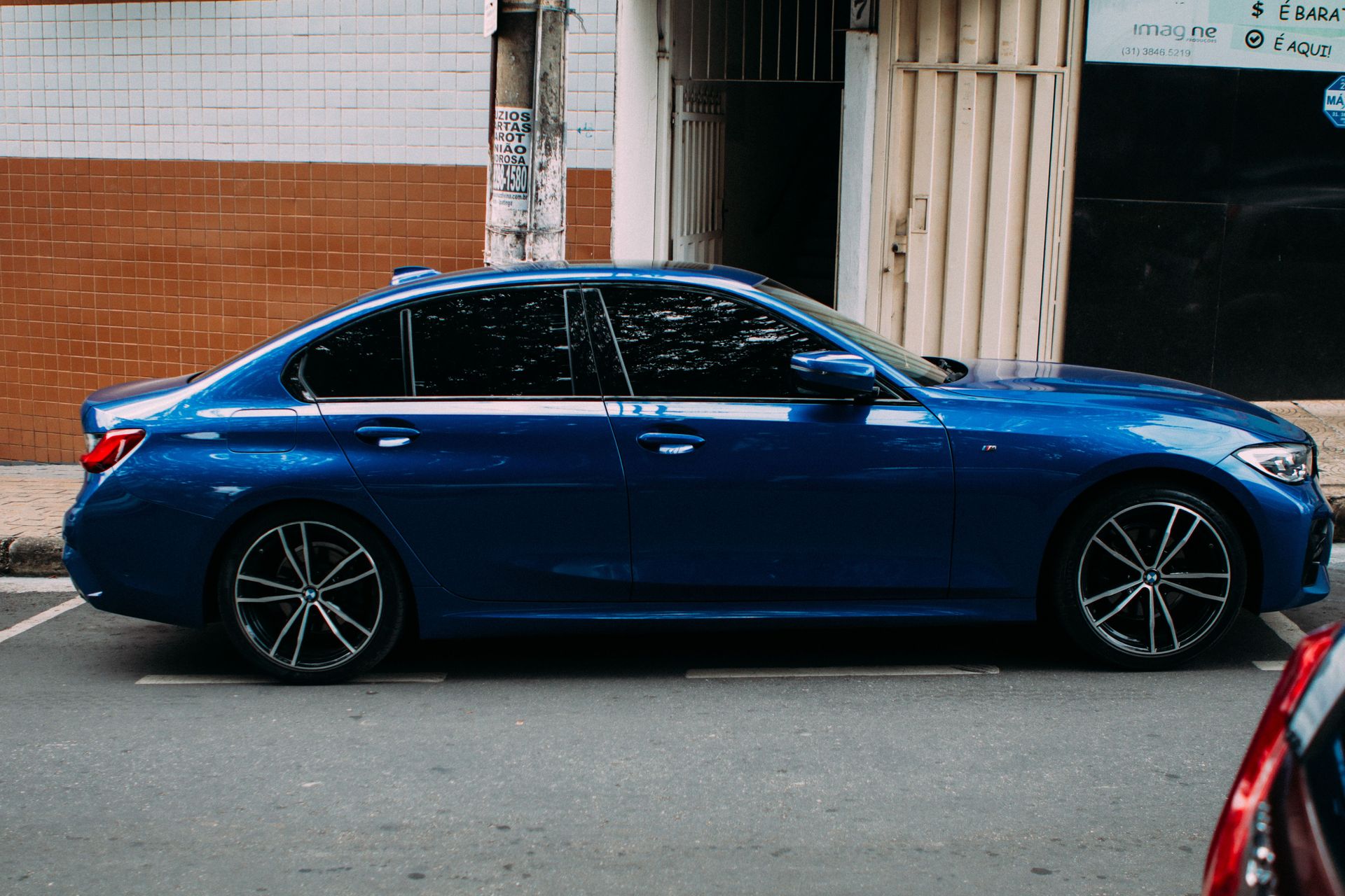A modern blue sedan parked on a city street, showcasing sleek design.